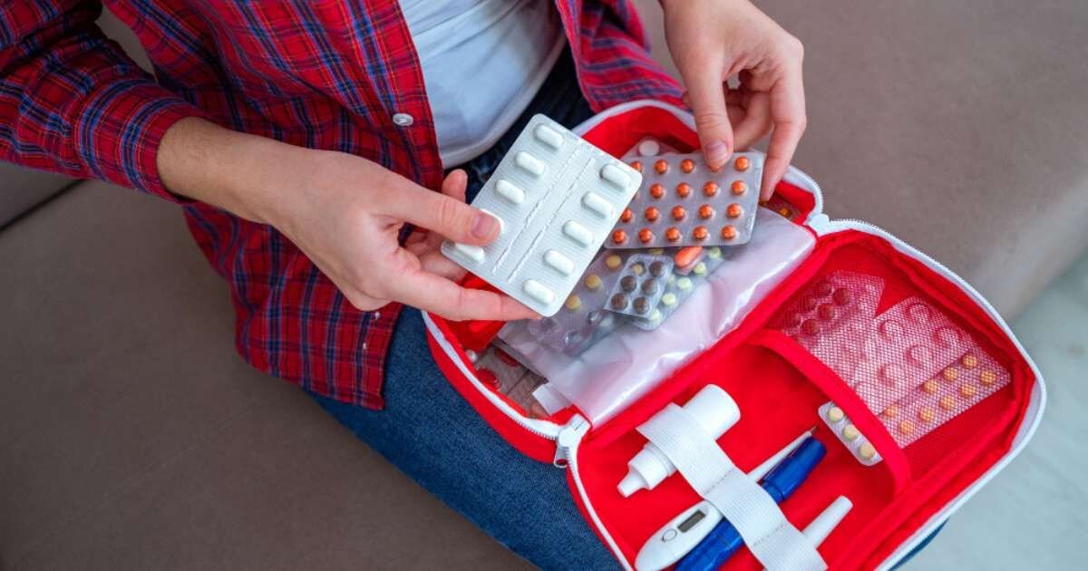 a person going through a medicine kit on there lap 