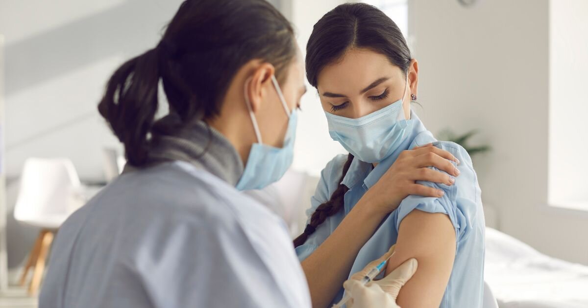 women wearing a mask getting a vaccine at the pharmacy 