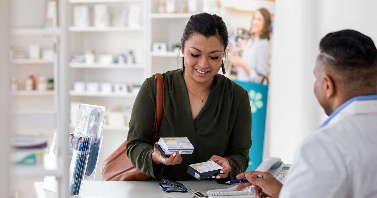 customer at the counter speaking with pharmacist 