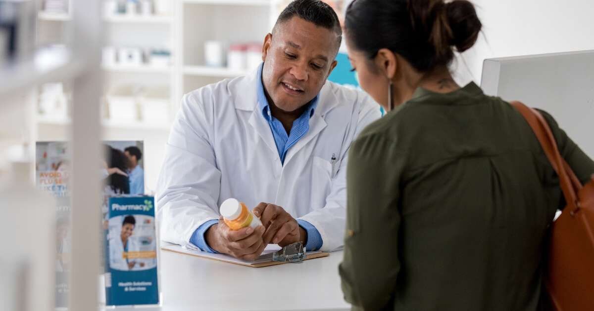 pharmacist discussing medication with a customer 