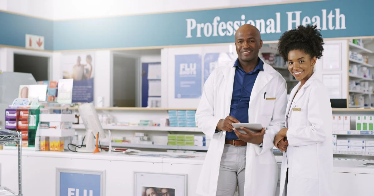 Professional pharmacy team standing in modern pharmacy