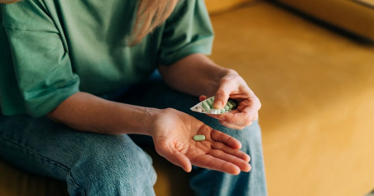 Person holding prescription pills in hand
