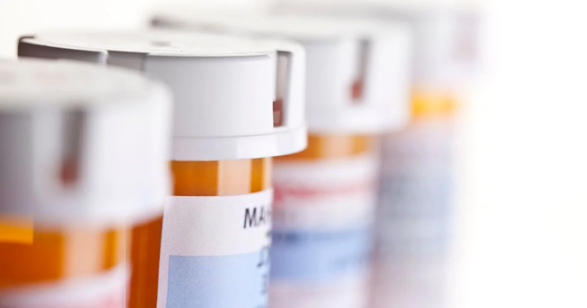 Close-up of prescription medication bottles on shelf
