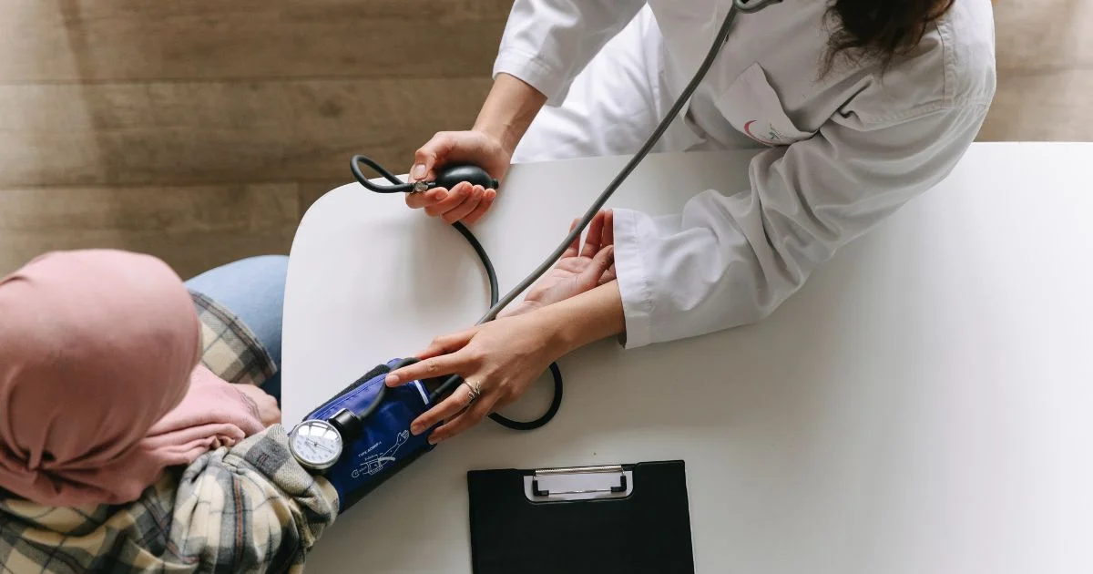 Healthcare professional taking patient’s blood pressure